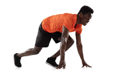 Portrait of young African-American man, athlete isolated over white background.