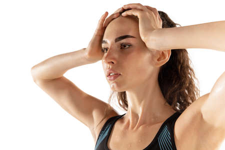 Close-up portrait of young girl female athlete isolated over white background.の写真素材