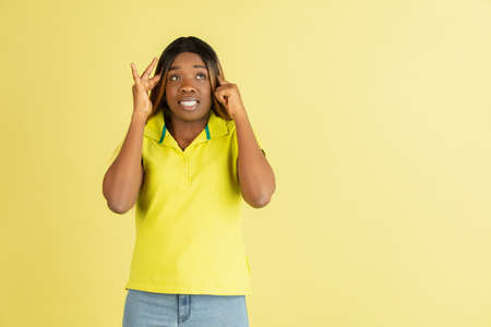 Beautiful African young woman posing isolated on yellow background.の写真素材
