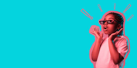 Portrait of little African-American girl isolated on blue background in neon. Flyerの写真素材
