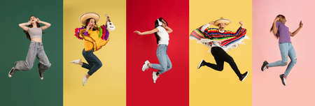 Group of people, young women and man jumping isolated over multicolored background.の写真素材
