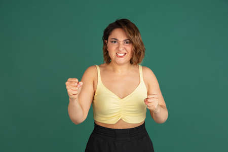 Young Caucasian beautiful woman in casual clothes isolated on green background.の写真素材