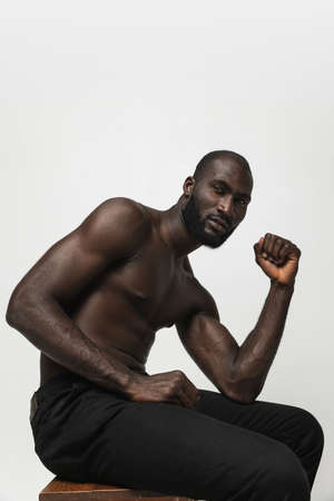 Young handsome muscled African man posing isolated over white background. Concept of beauty, cosmetics, spa.の写真素材