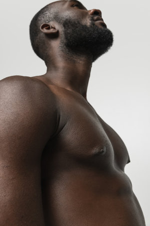 Close-up young handsome muscled African man isolated over white background. Concept of beauty, cosmetics, spa.の写真素材