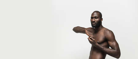 Flyer. Young handsome muscled African man posing isolated over white background. Concept of beauty.の写真素材