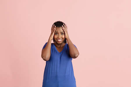 Half-length portrait of young beautiful girl in casual clothes isolated on light pink background.の写真素材