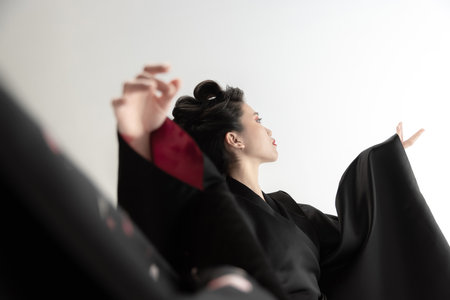 Portrait of young beautiful Japanese, woman in national attire kimono posing isolated over white studio background.の写真素材