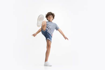Portrait of little preschool boy posing isolated over white studio background.