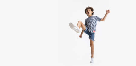 Flyer with portrait of little preschool boy posing isolated over white studio background.