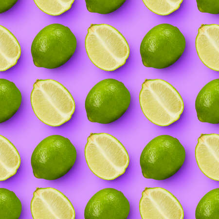Sour citrus. Wedges and whole green limes arranged over bright lilac background.の写真素材