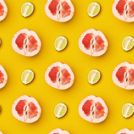 Creative collage, modern artwork. Juicy pieces of lime and grapefruit arranged over yellow background.の写真素材
