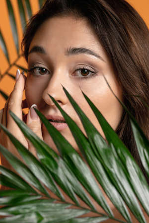 Happy smiling positive plus size woman. Face close up. Pretty caucasian female model at studio....