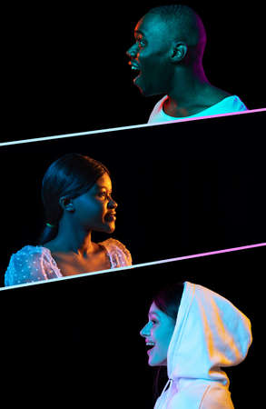 Side view portraits of three smiling, happy, positive people isolated over black background in neon lights.の写真素材