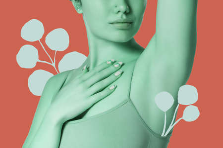 Cropped female body in underwear over red orange background decorated with cotton flowers. Beauty, fitness, skin care conceptの写真素材