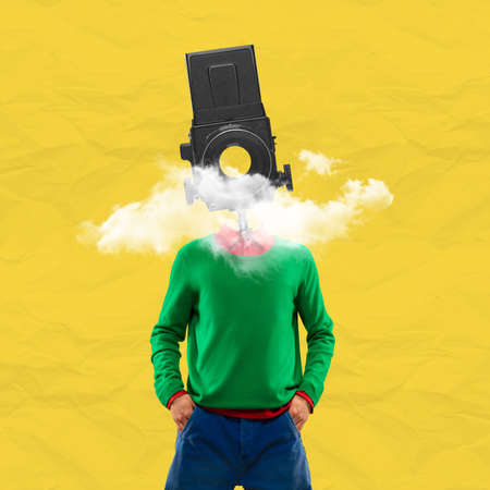 Surrealism. One young man in retro style clothes headed with old camera. Creative imageの写真素材