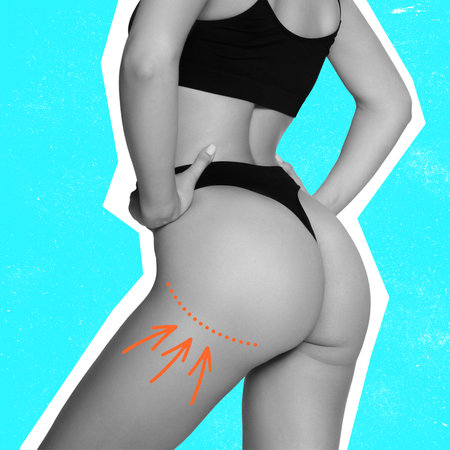 Cropped bw slim fitness female body in underwear isolated over light blue background. Concept of beauty, body and skin care, fat and cellulite removal, spa. back view. Arrows on bodyの写真素材