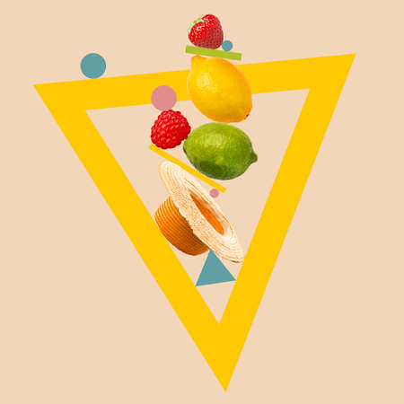 Fruit composition. Juicy citrus and berries in triangle frame over pastel background.の写真素材