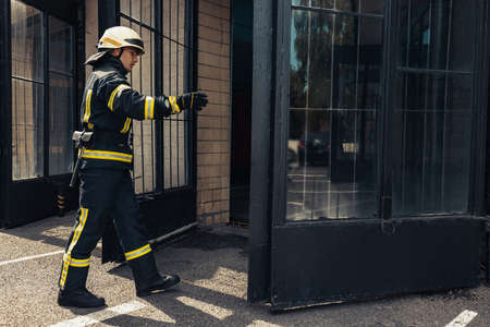 One male firefighter dressed in uniform with protective helmet at fire stationの写真素材