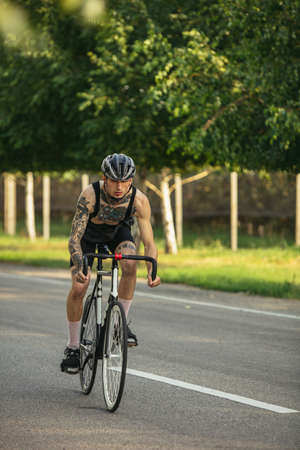 Young male cyclist riding a road bike in summer day. Action, motion conceptの写真素材