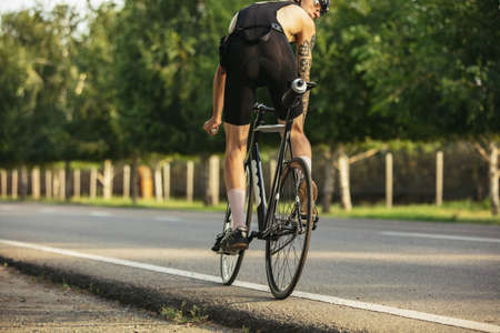 Young male cyclist riding a road bike in summer day. Action, motion conceptの写真素材