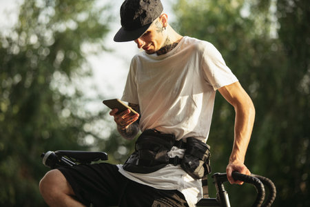 Stay tuned. Young male cyclist sitting on a bikeの写真素材