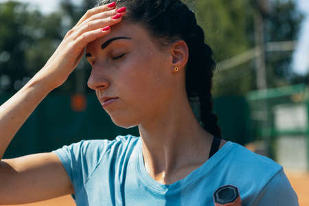 Close-up portrait of female tennis player after hard gameの写真素材