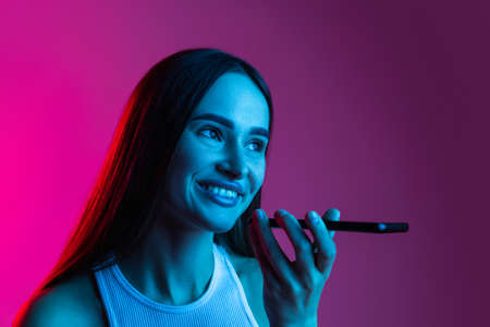 Beautiful young girl happily talking on her phone. Concept of communication