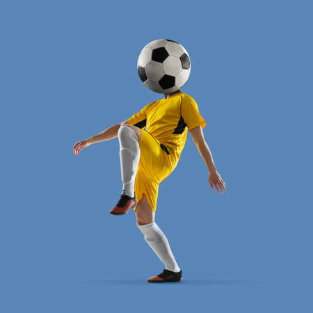 Colorful contemporary art collage of football player with ball instead head isolated on blue backgroundの写真素材
