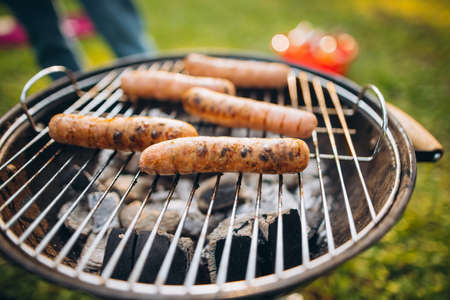 Close-up image of delicious sausages on grill for hot dogsの写真素材