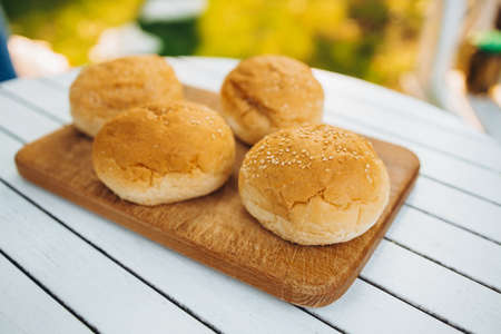 Tasty image of burger buns laying on cutting boardの写真素材