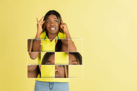 Art collage of young beautiful african girl isolated over yellow background. Chaotic arrangement of face parts, puzzle effectの写真素材