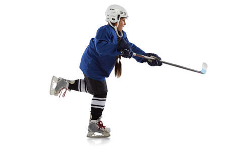 Full-length horizontal portrait of young female hockey player in blue uniform, with stick isolated...