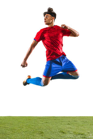Full-length portrait of young man, male soccer football player training isolated on white background.の写真素材