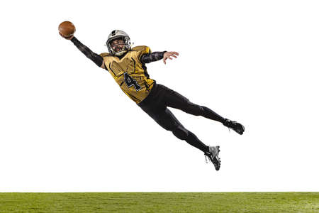 Full-length portrait of professional american football player in special uniform isolated over white grass flooring backgroundの写真素材