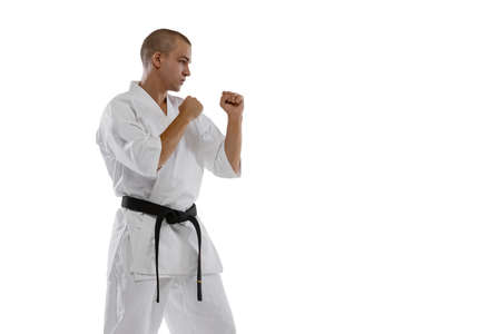 Side view portrait of one caucasian sportsman training isolated over white background. Karate, judo, taekwondo sportの写真素材