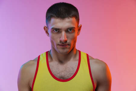 Cropped portrait of young male professional athlete isolated over gradient studio backgroundの写真素材