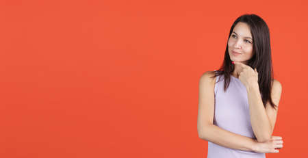 Cropped portrait of young beautiful woman isolated over red background. Flyer