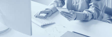 Cropped image of female hands working with computer. Business concept. Duotone effectの写真素材