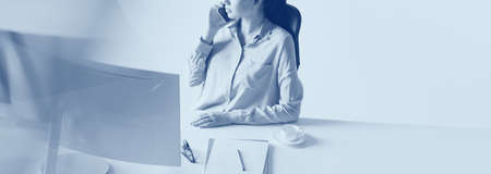Woman making important business call in the office. Career concept. Duotone effect