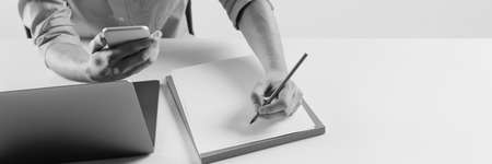 Top view image of young business man making notes. Professional growth. Black and white effectの写真素材