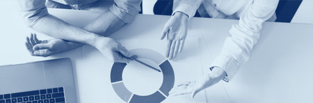 Top of two employees working together in he office. Financial diagram. Career concept. Duotone...