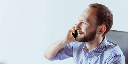 Side view close-up portrait of assistant director making business call in the office. Concept of work, careerの写真素材