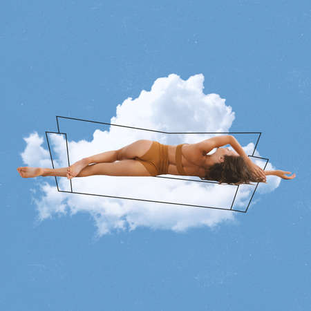 Contemporary artwork of tender woman lying on cloud in inner wear isolated over blue background. Fluffy cloudy bedの写真素材