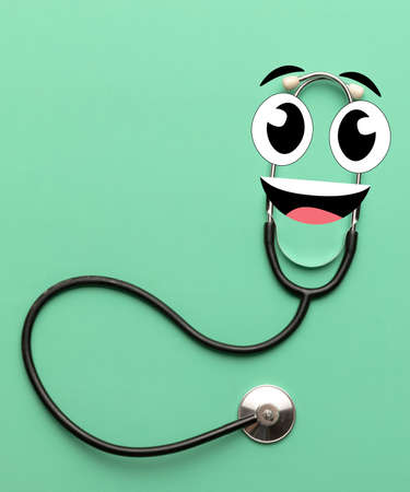 Contemporary art collage of phonendoscope with cartoon eyes isolated over green backgroundの写真素材