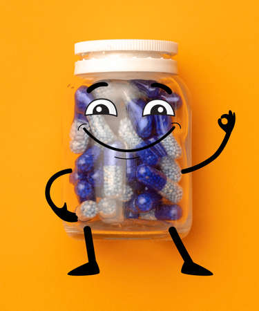 Contemporary art collage of capsule pill bottle with cartoon drawnings isolated over orange backgroundの写真素材