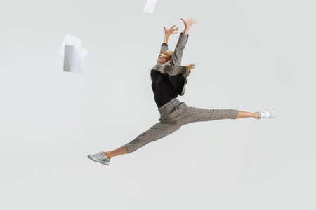 Full-length portrait of woman, office worker in a jump isolated over white background. Weekend time
