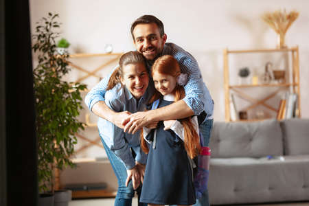 Portrait of happy family, father, mother and daughter hugging. Family supportの写真素材
