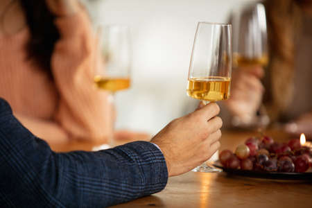 White wine glasses. Group of friends visiting gastronomic festival at cafe. Degustation