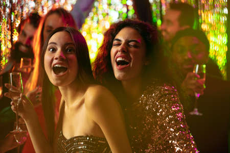 Young, happy, excited friends having fun at the party. New Year celebration gathering