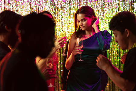 Cropped portrait of young beautiful girl enjoying party with friends, dancing, laughing